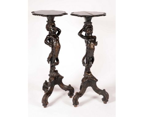 A pair of Venetian Blackamoor torcheres, each with shaped plateau above a scantilly clad attendant, tripod bases, 114m high, 