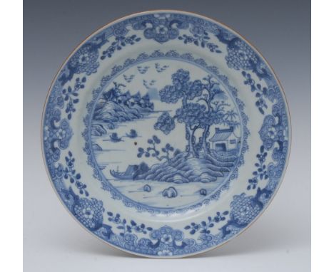 A Chinese circular plate, decorated hut, trees and rock, elaborated scroll border, brown line border, 22.5cm diam, c.1770 Con