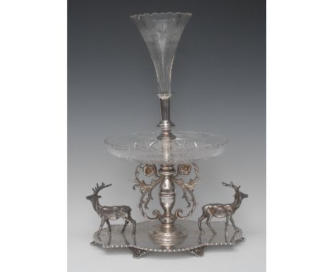A Victorian E.P.N.S table centrepiece, central cut glass epergne flute above a shallow dish, the shaped quatrefoil base with 