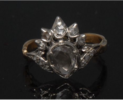 A 19th century diamond crown ring, central pear drop old mixed cut diamond, beneath a five point crown arch, encrusted with t