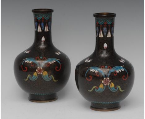 A pair of Chinese cloisonné enamel ovoid vases, decorated in polychrome and inlaid with scrolling wire, 16.5cm high