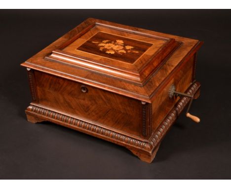 A 19th century walnut and marquetry Polyphon, the horizontal mechanism playing 40cm discs, hinged cover quarter-veneered and 