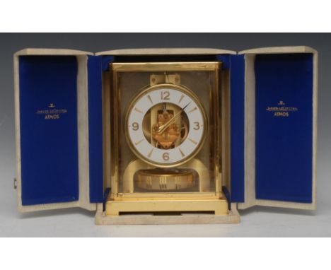 A Jaeger-le-Coultre lacquered brass Atmos clock, 11cm circular dial with baton markers and Arabic numerals at quarters, seria