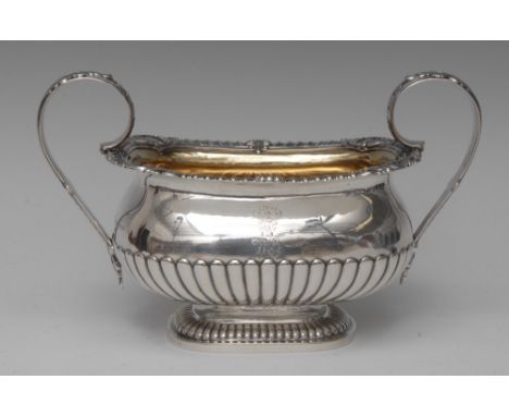 Paul Storr - a large George III silver half-fluted boat shaped sugar basin, scroll handles, gadrooned everted rim with anthem