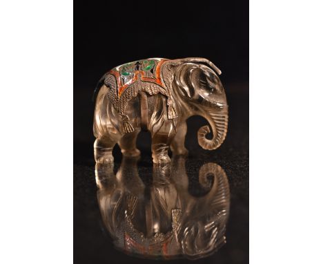 A carved rock crystal enamel and metal elephant, carved standing with ornate cast and enamelled base metal floral ceremonial 