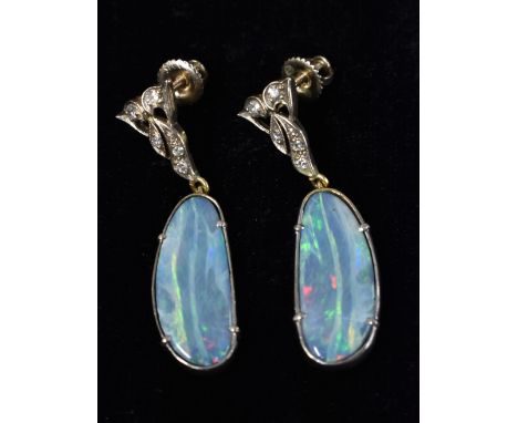 A pair of black opal and diamond earrings, sinuous elongated triangular stud inset with five round cut diamond accents, above