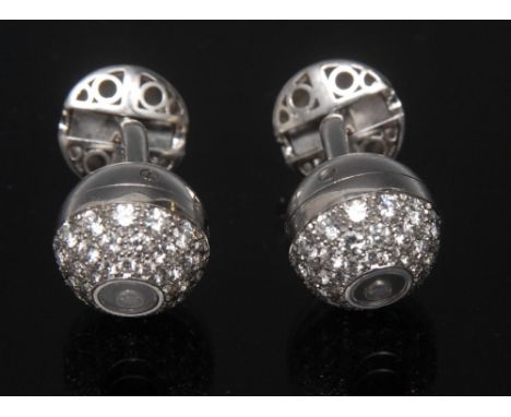 A pair of Chopard diamond encrusted 18ct gold cufflinks, each with a single floating round brilliant cut diamond within a for