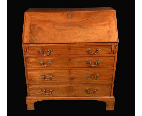 A George III mahogany bureau, fall front enclosing a cupboard door and an arrangement of pigeon holes and small drawers, abov