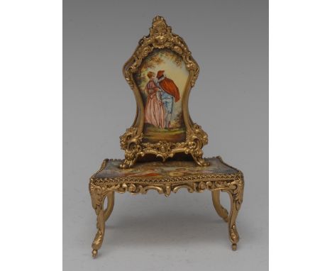 A Continental enamel and gilt metal musical miniature model, of a Louis XV bonheur du jour, decorated in polychrome with a co