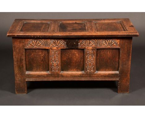 A Charles II oak three-panel blanket chest, hinged top above a lunette carved frieze, stile feet, 55cm high, 106cm wide, c. 1