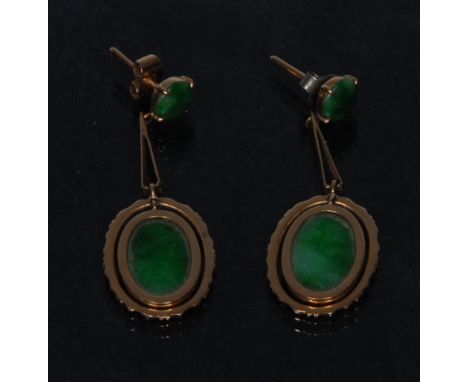 A pair of jadeite and yellow metal droplet earrings, oval hinged jadeite panel within surrounding floral frame, suspended fro
