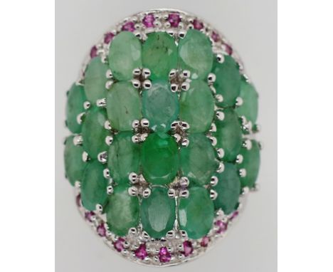 Emerald, ruby and sterling silver ring 22x oval cut emeralds approx 6mm x 4mm each, 20x round brilliant cut rubies. 15 grams 