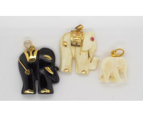 Three vintage carved elephant charms to include two carved ivory pieces. marked 14k 585 to the largest ivory piece which is a