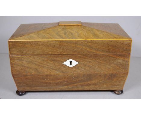 Regency rosewood caddy of canted sarcophagus form, with brass ring handles and shaped ivory escutcheon, matching interior can