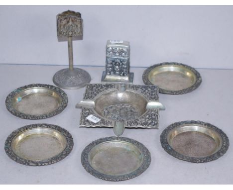 Eight Indonesian silver ashtrays & smokers ware including square ashtray, and matching cigar lighter, a match box holder on s