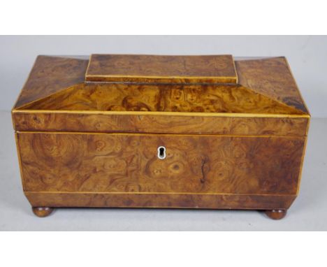 Regency burr yew tea caddy of canted sarcophagus shape, with triple section interior of rosewood and ivory thread escutcheon.