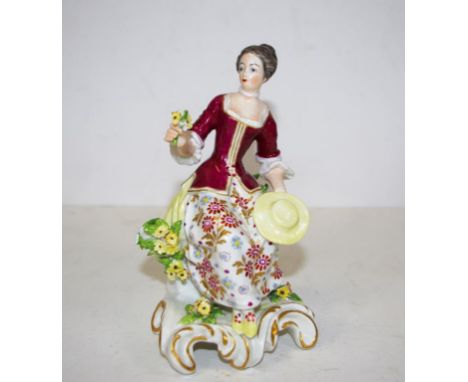 Antique Chelsea style figurine Seated woman with flowers. Gold anchor mark verso. Height 16cm approx.