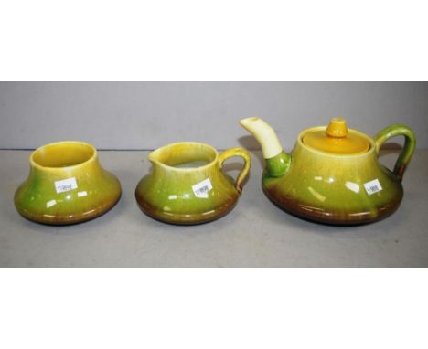 Three piece Newtone Australian pottery teaset including teapot, creamer and sugar bowl, marked to base.  Damage to spout