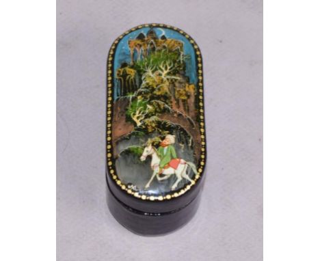 Russian lacquer lidded trinket box hand painted figure on horseback scene. Length 8.5cm approx.