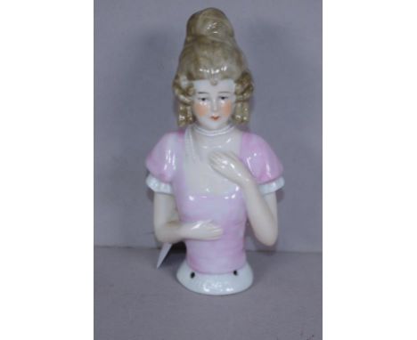 Vintage ceramic half doll in period pink dress, unmarked, (possibly German). Height 11cm approx.