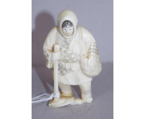 Antique Japanese ivory netsuke -Revolving face man in traditional mountain climbing clothes, C1920, signed to base, 6.5cm hig