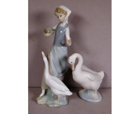 Lladro figure - girl feeding goose 24.5cm high approx., together with a Nao duck figure