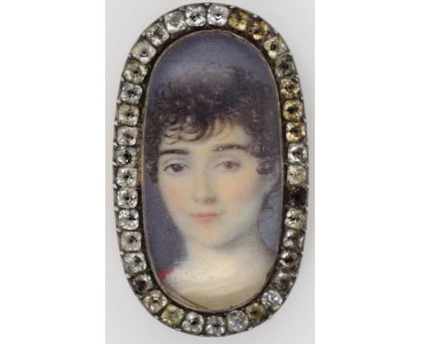 Georgian miniature portrait brooch gold backed set with a paste stone surround. Unmarked approx 35mm x 20 mm