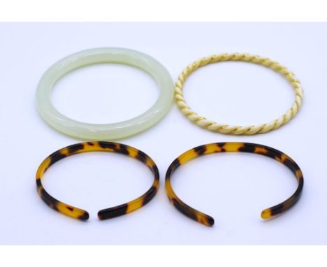 Four ladies bangles include to carved tortoiseshell pieces, a carved rope twist and gold mounted example as well as a jade pi
