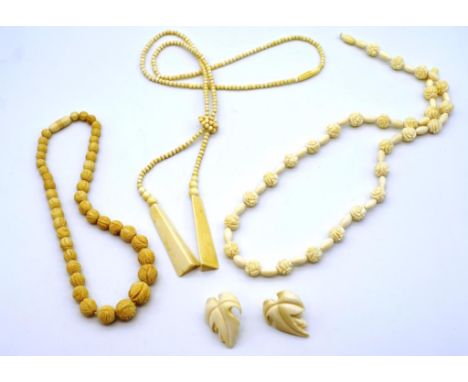 A collection of vintage carved ivory jewellery to include three beaded necklaces and a well carved pair of leaf form earrings