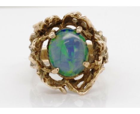 Vintage opal & 9ct gold ladies ring of a molten textured form with a central opal doublet. marked 9ct with other rubbed marks