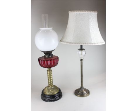 A brass and glass column table lamp, together with a converted oil lamp with white glass shade on red faceted glass body, 69c