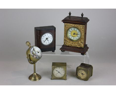 A British United Clock Company bedside clock, three other small clocks including a Zenith and a magnified clock modelled as a