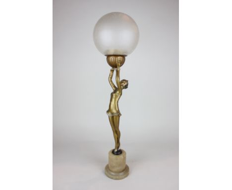 An Art Deco style lamp modelled as a resin figure of a lady in leotard holding a glass light fitting on stone base, 61cm high