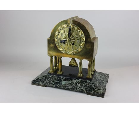 An Art Nouveau brass mantel clock by Lenzkirch, the circular embossed face with Arabic numerals, the exposed pendulum hanging