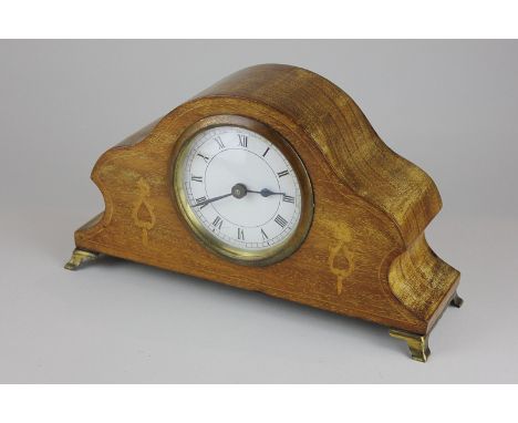 A mahogany cased mantel clock with circular white dial and Roman numerals
