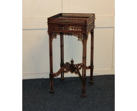 A Chippendale style side table with galleried top, two slides, latticed sides and supports, on bamboo legs, 32cm square