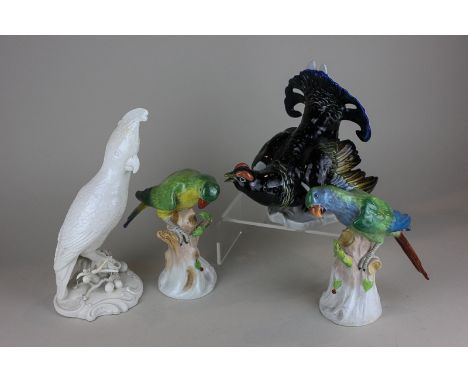 A pair of Dresden porcelain parakeets, a capercaillie and a model of a cockatiel in white glaze, 2.5cm high