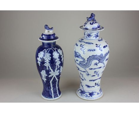 Two Chinese porcelain vases and covers,  both blue and white, baluster shape, one of dragons chasing the flaming pearl, with 