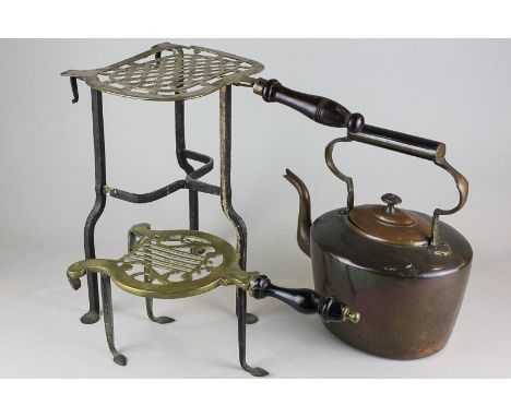 Two brass trivets, one in the form of a harp, together with a copper kettle
