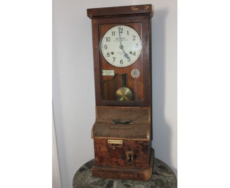 A National clocking in and out time recorder, the clock face marked National Time Recorder Co Ltd, St Mary Cray, Kent, 36cm b