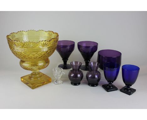 An amber glass fruit bowl on stand, a pair of blue glass goblets, a pair of amethyst glass vases, goblets, a bowl and an egg 