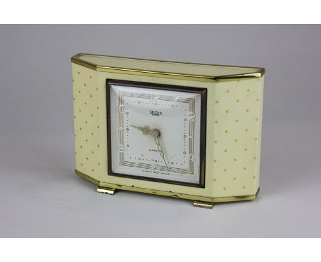 An Art Deco Smiths Empire alarm clock decorated with gilt stars, the square face with Arabic numerals
