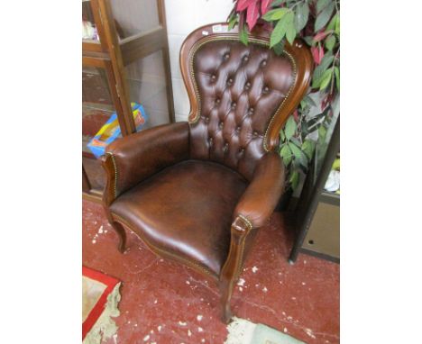 Button-back leather armchair