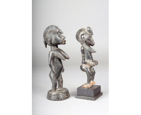 Two Senufo standing female figures, Ivory Coast, 20.5cm and 16.5cm high, the smaller with a stand. (2) Provenance The Bιguι c