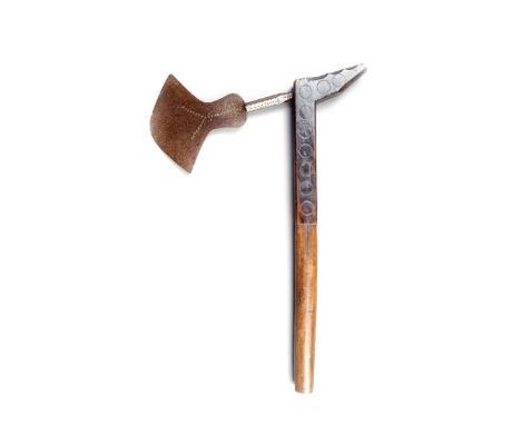A South African axe, with a shaped blade stamped x's with a wood handle, carved and faceted with circle designs and with ebon