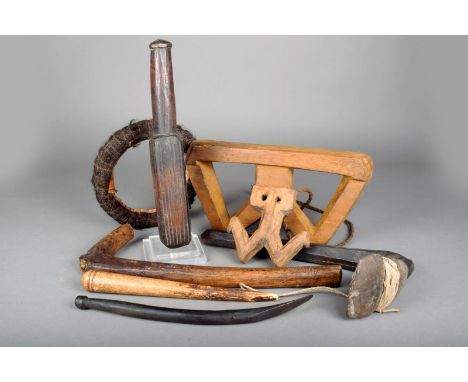 A Solomon Islands barkcloth beater, 34cm long, two axe handles, one bound with an associated stone head, a large net needle, 