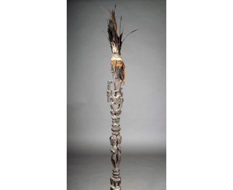 A Batak magician's staff, Indonesia, with ancestor figure, with feathers and fibre above further figures and animals, 172cm l