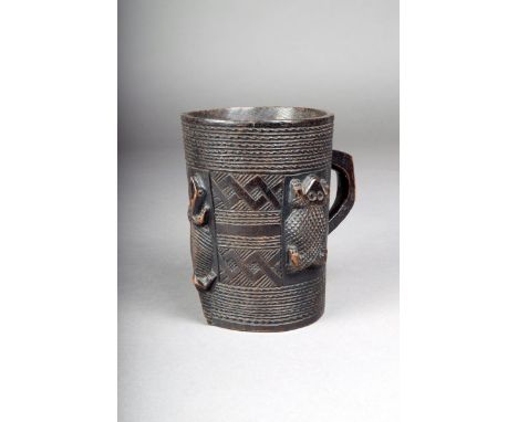 A Kuba cup, D. R. Congo, wood, carved a handle and two frogs and a lizard in relief, 13.5cm high.