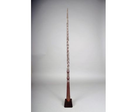 A Vanuatu dagger, Melanesia, carved a stepped tip and barbs, with flattened knops and a faceted handle, 85.5cm long, in a sta