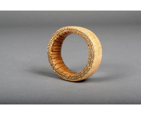 An African ivory bangle, early 20th century, 9cm diameter.